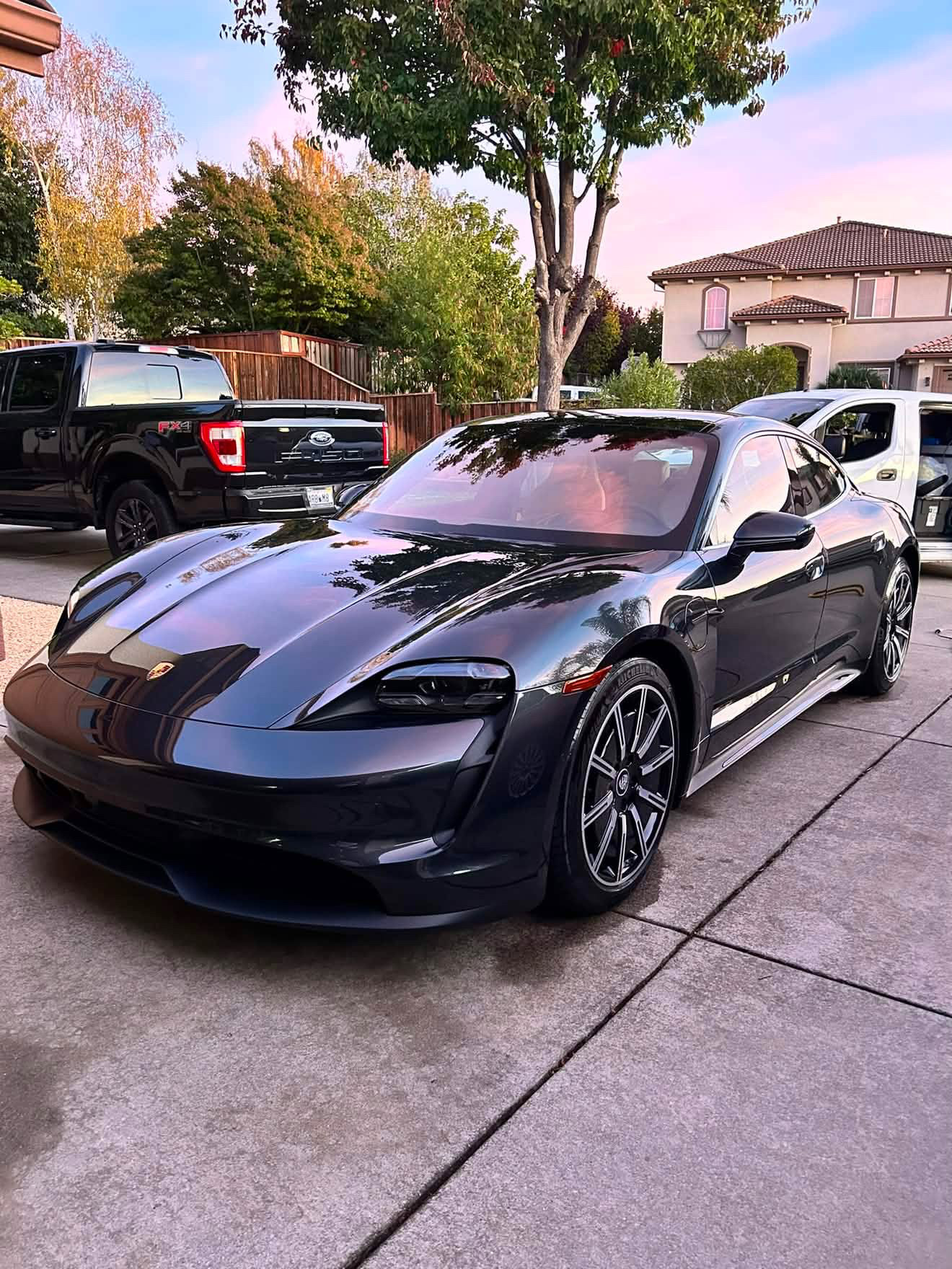 Black Porsche parked in a driveway after detailing