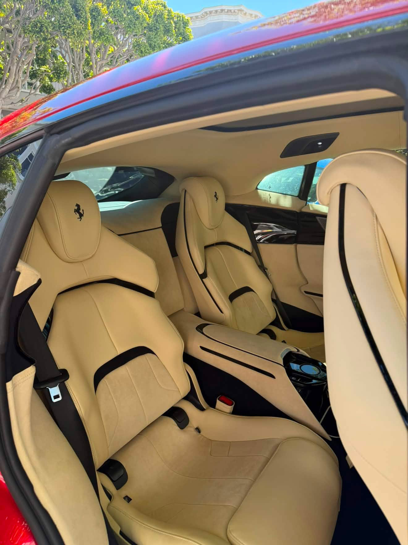 Clean cream leather seats inside a red Ferrari