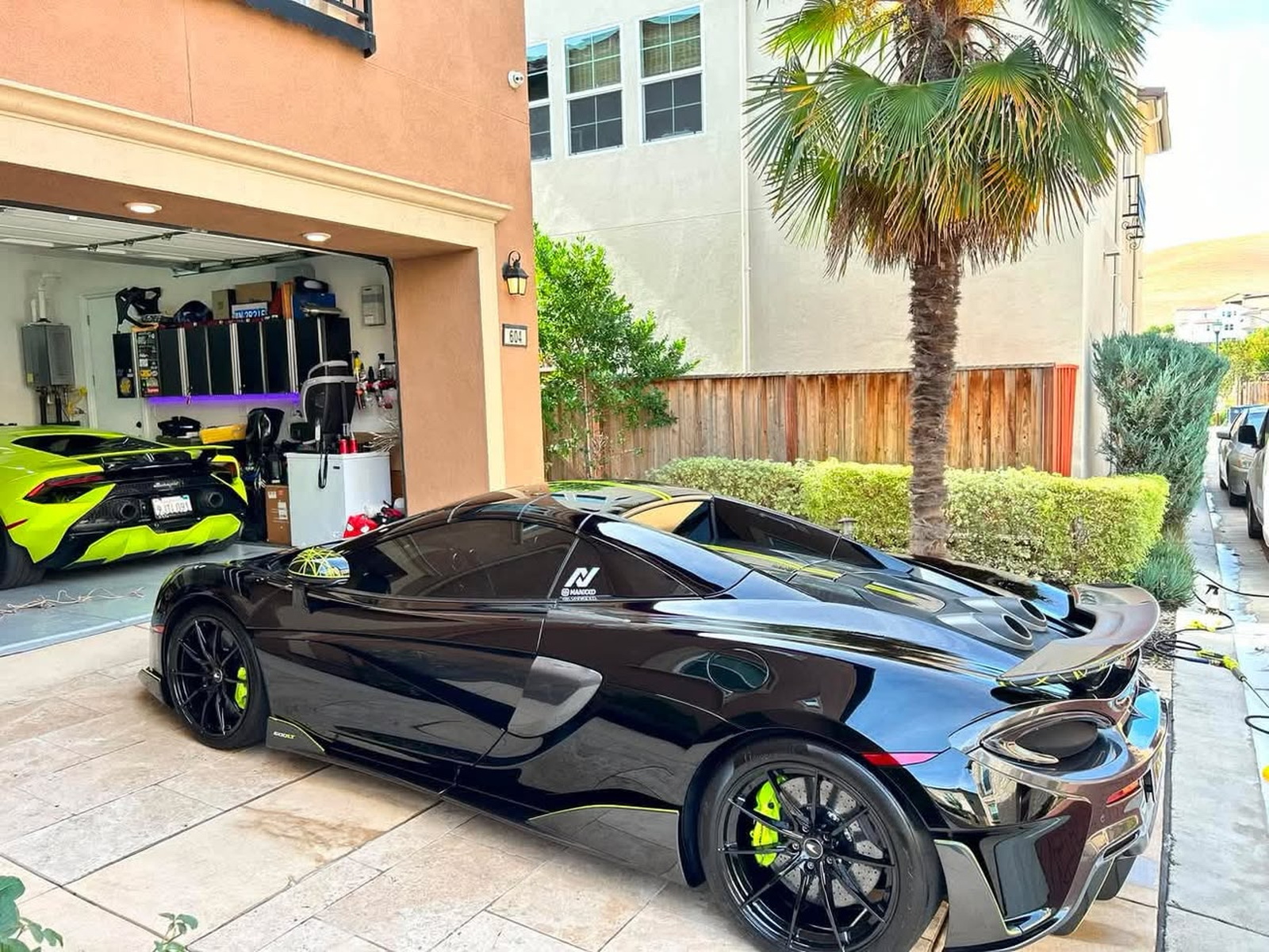 Black McLaren parked at a residential mobile detailing setup