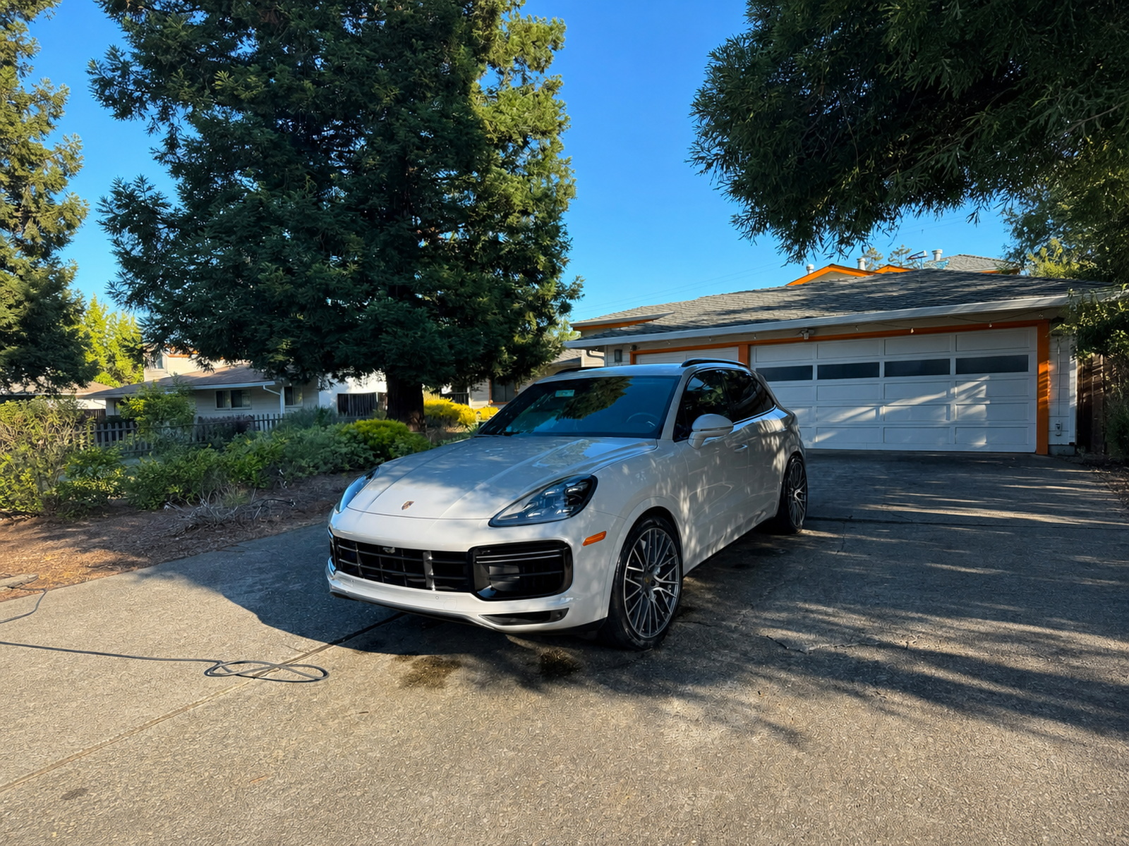 White Porsche SUV after a driveway mobile detail