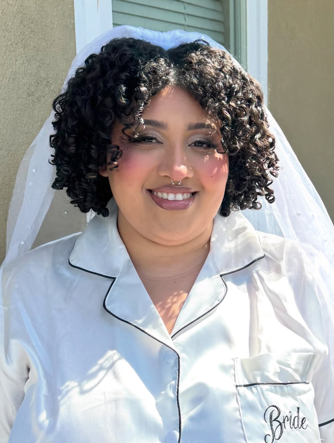Smiling bride wearing softly defined wedding-day makeup
