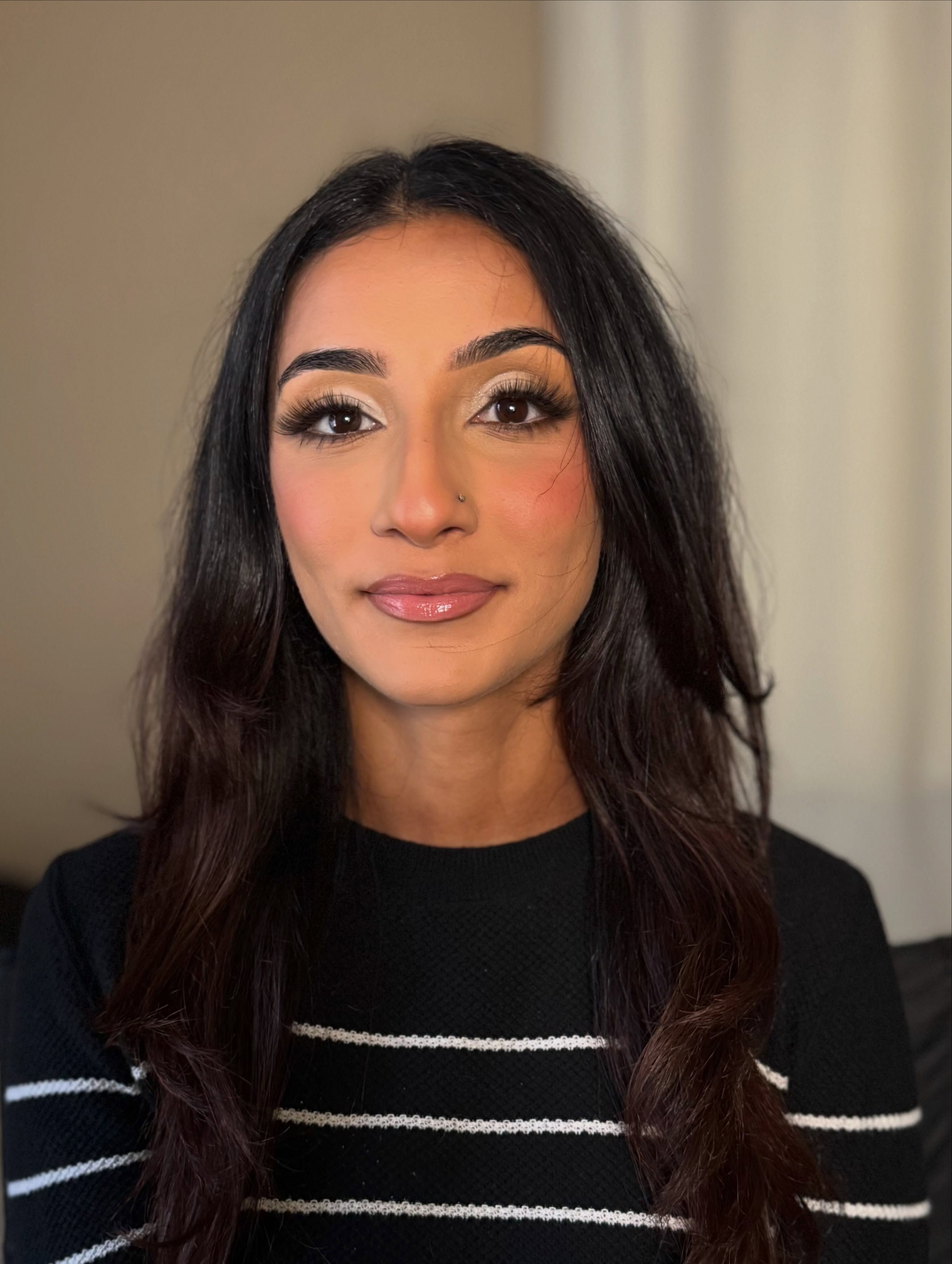 Client wearing softly defined neutral glam with luminous skin