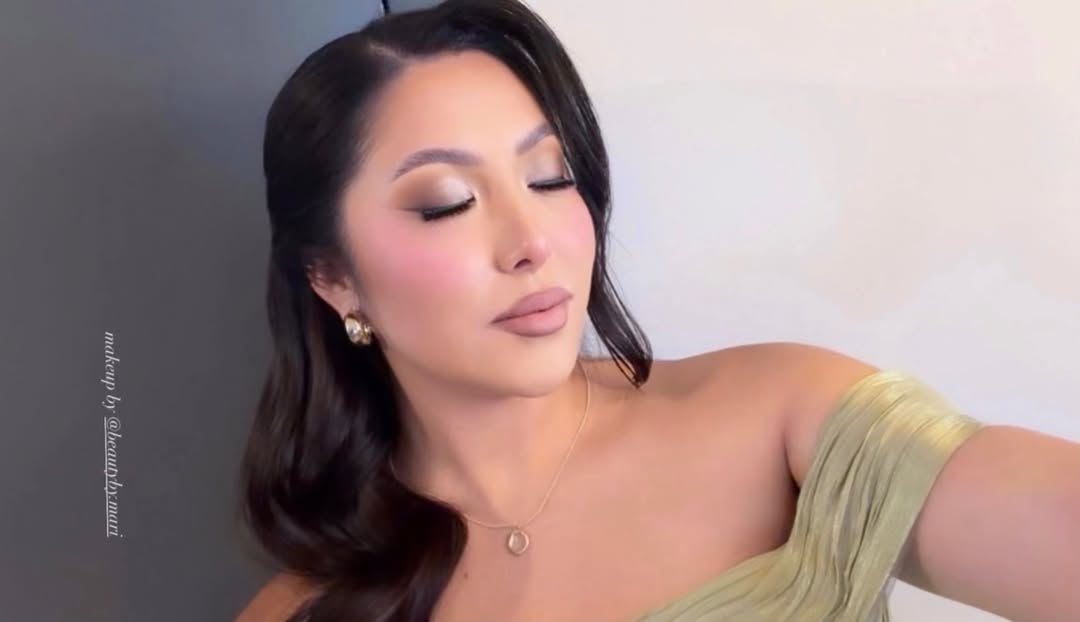 Client wearing polished soft-glam makeup in a landscape portrait