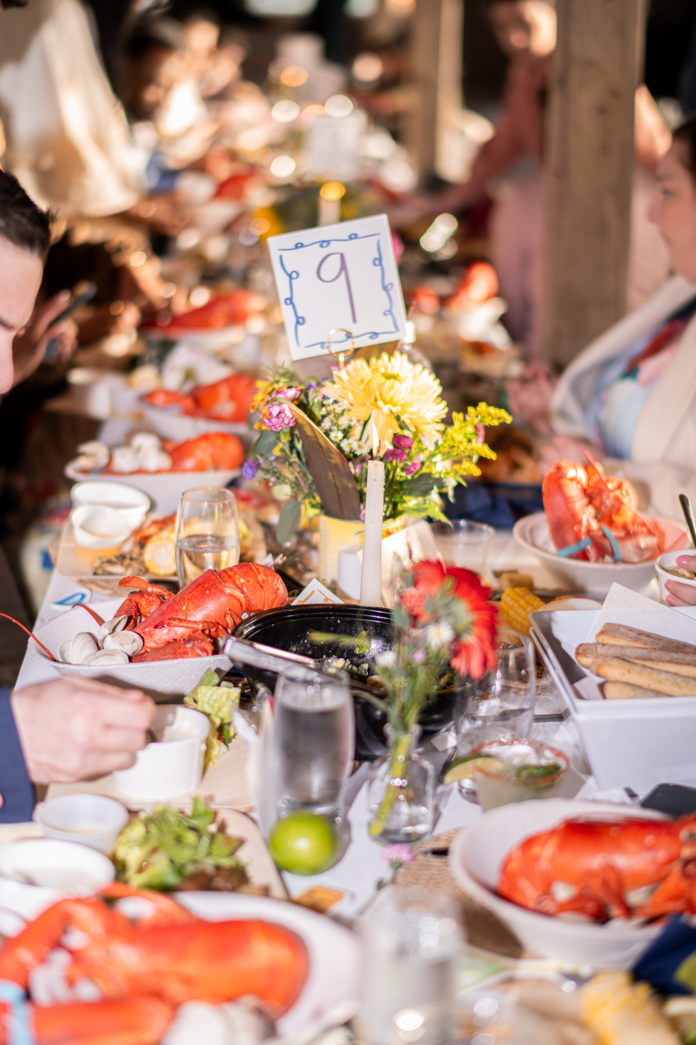 Colorful dinner celebration with flowers and shared seafood
