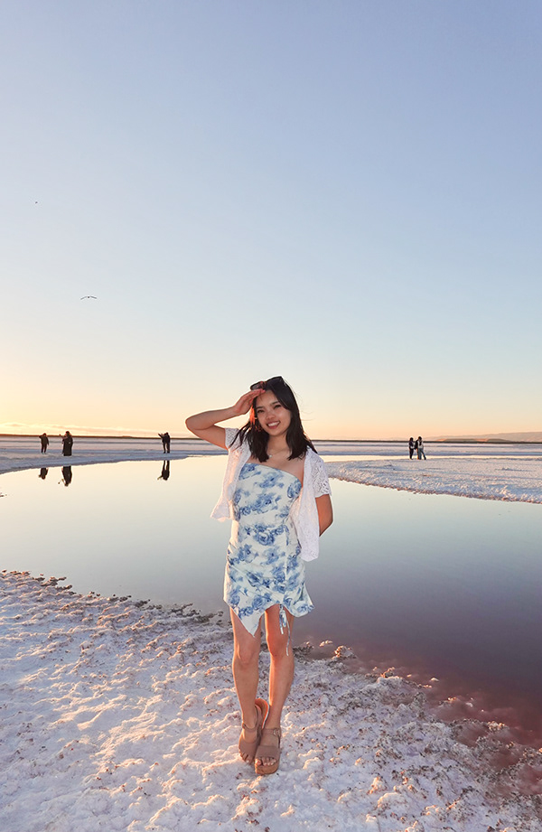 Portrait of photographer Tiffany by reflective water at sunset